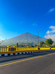 View of the bridge with the mountain in the background. Sigandul Bridge and Mount Sumbing.