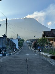 Beautiful rural view on a mountain slope with Mount Merapi in the background.