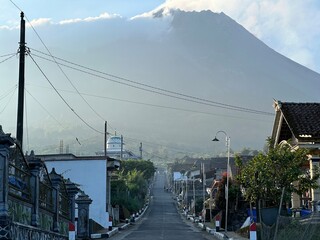 Beautiful rural view on a mountain slope with Mount Merapi in the background.