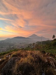 View of sunrise with reddish sky in a mountainous landscape. Kejajar, Wonosobo, Indonesia.