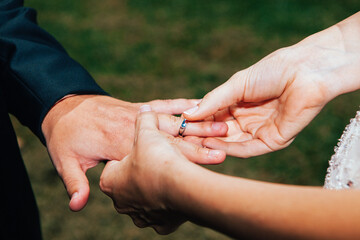 Closeup shot of the hands of the man and woman showing their wedding or engagement ring
