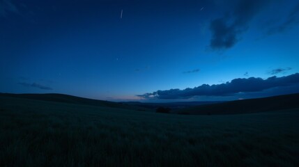 Naklejka premium Serene Night Sky Over Rolling Hills and Grassland at Dusk