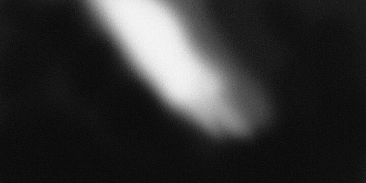 Abstract black and white gradient texture with light flare gradient grainy background.