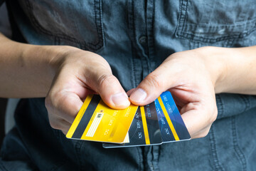 woman holding credit cards and he is choosing a credit card to pay and spend Payment for goods via...