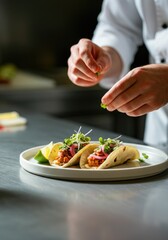 Chef Finishing Elegant Tacos with Fresh Ingredients in a Modern Kitchen