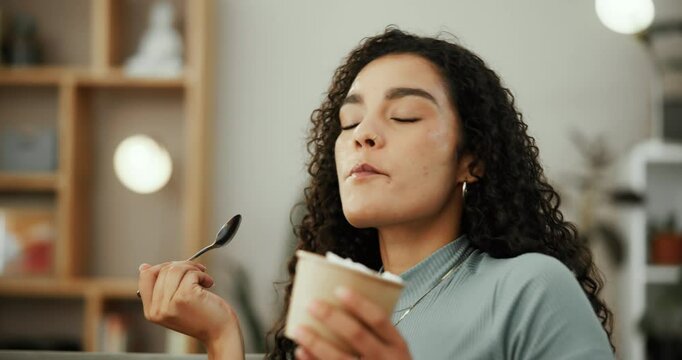 Woman, eating ice cream and smile in house living room with satisfaction, summer pleasure and sweet tooth. Comfort food, fun snack or happy girl on couch with taste of frozen vanilla dessert in home
