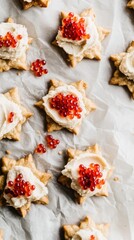 Mini snowflake-shaped crackers with salmon mousse and caviar topping