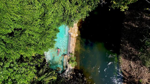 Experience the beauty of Thailands untouched natural pools nestled in a vibrant jungle. Embrace the tranquil waters and lush surroundings, top view at a swimming pool in the jungle rainforest 
