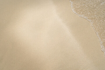 Summer waves crash on the sandy beach