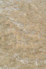 Summer waves crash on the sandy beach