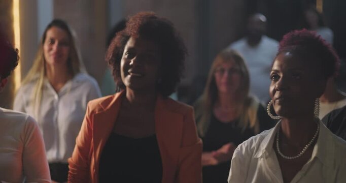 Group of women smiling and standing in worship, diverse congregation expressing faith and joy, Christian spirituality in a church environment, community unity and praise