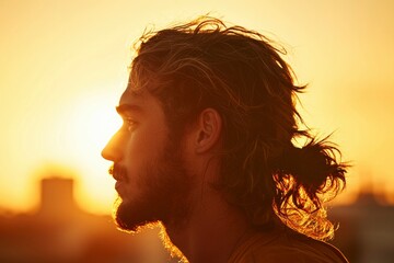 A man observes city sunset skyline. Silhouette of buildings in the background
