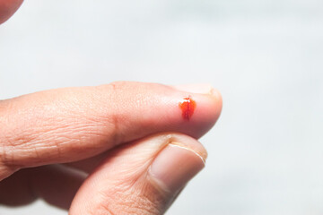 cut wound on finger on white background