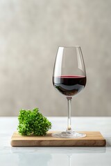 Elegant Red Wine Glass on Wooden Board with Green Herb