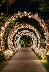 Fototapeta premium Illuminated floral archway path, tropical garden night wedding