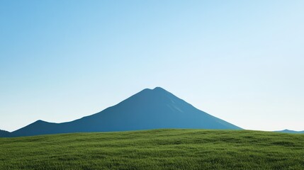 Fototapeta premium Serene mountain vista, green field, clear sky; idyllic nature scene for travel or landscape designs