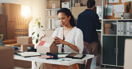 Woman, courier box and delivery in office, open package and commercial supply chain at desk,...