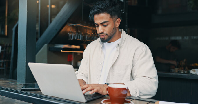 Thinking, laptop and man in restaurant, coffee and remote work with content creation. Person, writer and freelancer with pc, research for article and editing for cafe review and email notification