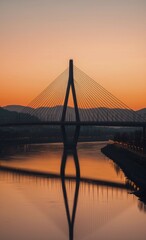 Obraz premium Scenic river reflects the bridge at dusk, with mountains and twilight sky