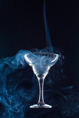 levitating glass full of smoke on a black background