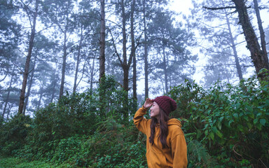 Portrait image of a woman traveling and looking at the forest