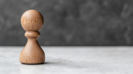 Wooden pawn on a gray background, business concept, leadership