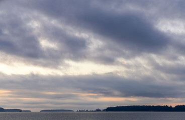 Peaceful Sunset Scene Over Serene Waters and Forested Islands