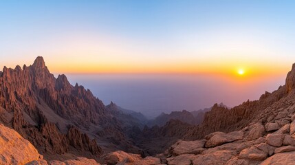 Majestic Sunrise Over Rocky Mountains and Valleys in a Tranquil Desert Landscape