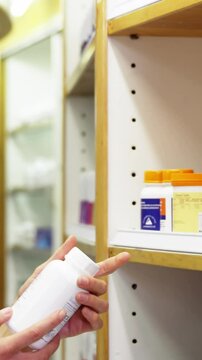 Pharmacist checking a bottle of drug