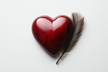 A red heart object resting against a brown feather