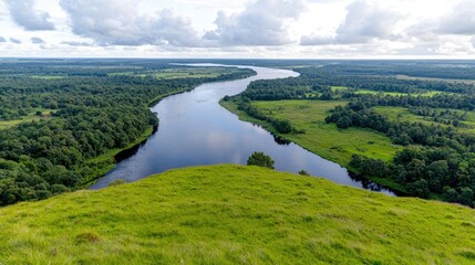 Fototapeta premium River bends through green landscape, aerial view