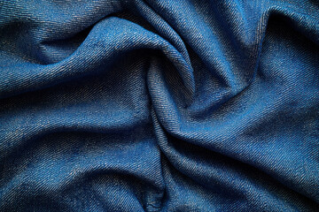 Fototapeta premium Folded blue denim fabric texture background for apparel design