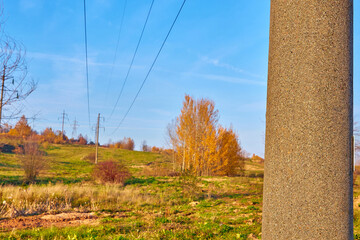 A pole with a sign on a high-voltage power line