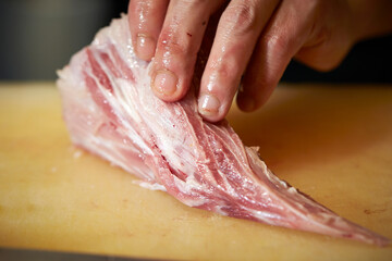 Cut the tuna chunks with a knife