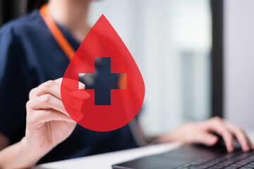 Professional health care worker doctor physician holding blood icon for blood donation concept