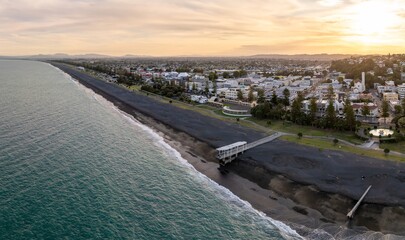Panoramic view of Napier, with a pier and people enjoying the beach. Coastal town, New Zealand. Marine Parade, Napier, Hawke's Bay, New Zealand