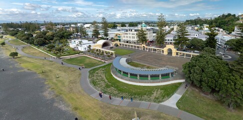 Aerial view of Marine Parade. Pedestrians stroll through the park, enjoying the sunny day. Public...