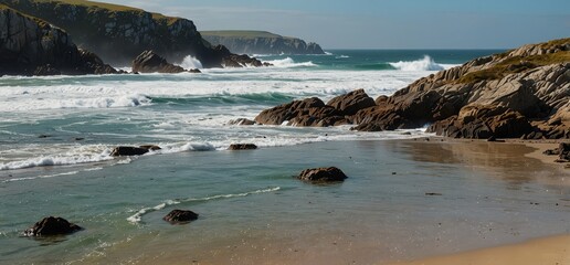 Striking coastal view of seals on a beach, with waves and dramatic cliffs.

