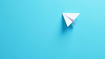 A solitary paper airplane gracefully glides across a vibrant azure backdrop, symbolizing dreams of flight and the boundless possibilities that await.