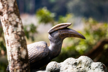 Concrete hornbill bird on tree. Picture clicked at Thekkady boat house, Idukki district, Kerala, India © 3RdEYE Photo Co.