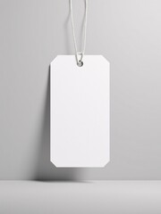 A clean white tag mockup hanging freely, casting a soft shadow on a neutral gray background.