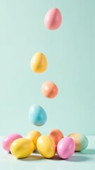 Obraz premium Easter eggs falling from top to bottom on a light background, space for advertising, text, words