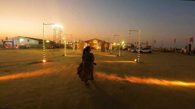 Young Woman Entering Decorated Rann Utsav Tent at Night