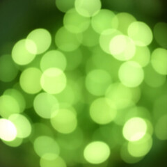 Obraz premium Green bokeh lights creating a festive and glowing abstract background