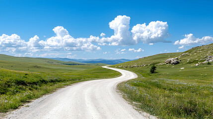 Winding dirt road through grassy hills, sunny day, scenic landscape, travel photography