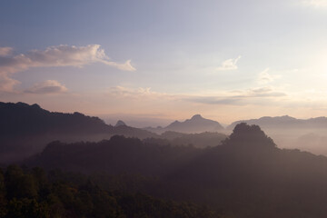 Landscape mountain with mist in morning sunrise.