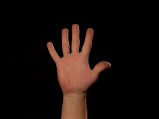 A hand with five fingers is raised