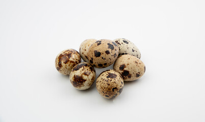 The Common quail (Coturnix coturnix) eggs on a white background.