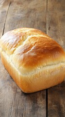 Naklejka premium Freshly baked loaf of bread on wooden table in kitchen setting