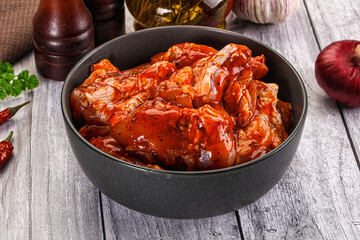 Raw marinated buffalo chicken wings